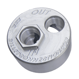 A round metallic component with two hexagonal openings and labeled text.