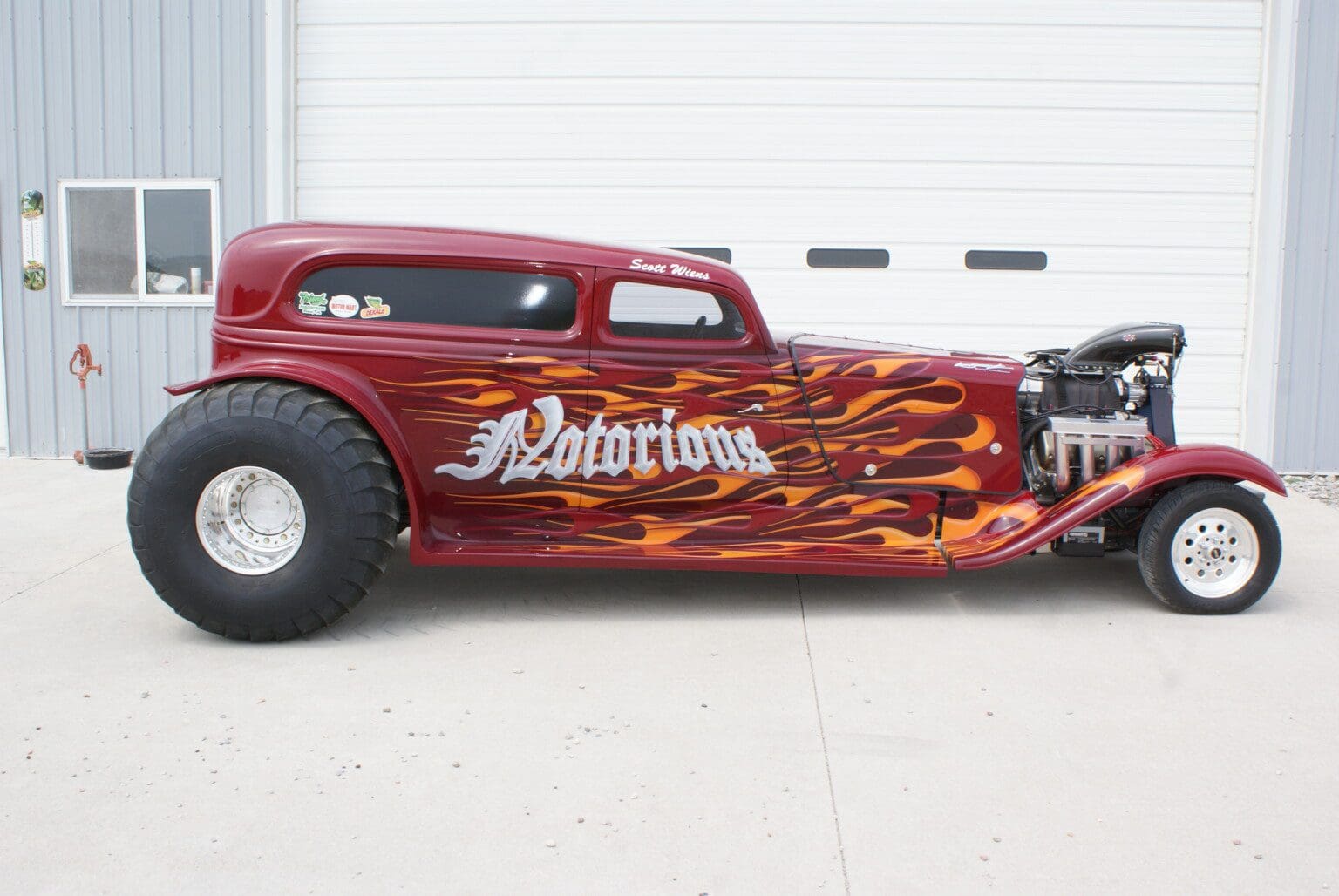 Custom hot rod with flame decals and 'Notorious' lettering.
