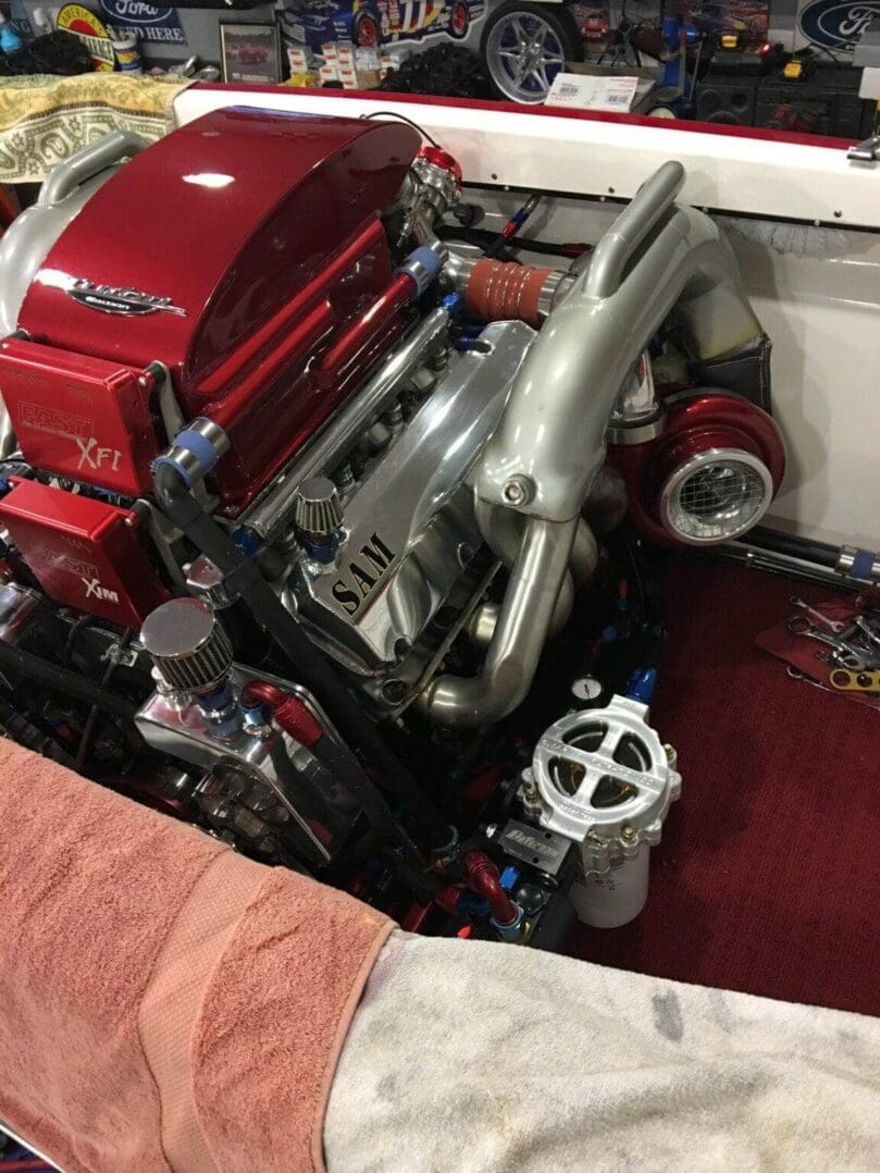 Close-up of a polished engine with red and silver components in a clean engine bay.