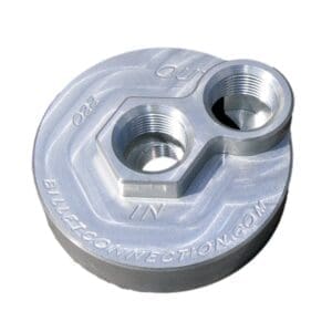 A metallic, round mechanical part with two holes and engraved text.